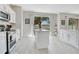 Bright kitchen with stainless appliances features a kitchen island and a backyard view at 9846 Palmetto Dunes Ct, Orlando, FL 32832