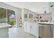 Bright kitchen with stainless appliances features a breakfast bar and direct access to the outdoor patio at 9846 Palmetto Dunes Ct, Orlando, FL 32832