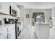 Bright kitchen with stainless appliances features a kitchen island and a backyard view at 9846 Palmetto Dunes Ct, Orlando, FL 32832