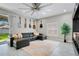 Cozy living room features a comfortable sectional, stylish rug, and a large window at 9846 Palmetto Dunes Ct, Orlando, FL 32832