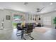 Open-concept living and dining area with sliding glass door to backyard at 9846 Palmetto Dunes Ct, Orlando, FL 32832