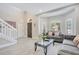 Comfortable living room features natural light, a stylish sofa, and neutral décor at 9846 Palmetto Dunes Ct, Orlando, FL 32832