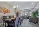 Open-concept living space featuring a gray sofa and dining area at 9846 Palmetto Dunes Ct, Orlando, FL 32832