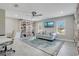 Living room with a large built-in bookshelf, a sectional sofa, and a television at 9846 Palmetto Dunes Ct, Orlando, FL 32832
