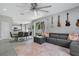 Open-concept living room with sliding glass doors, sleek flooring, and an elegant rug at 9846 Palmetto Dunes Ct, Orlando, FL 32832