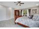 Spacious bedroom featuring tile floors, ceiling fan, balcony access and an elegant wardrobe at 9846 Palmetto Dunes Ct, Orlando, FL 32832