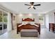 This main bedroom has a large bed, ceiling fan, and access to a private balcony at 9846 Palmetto Dunes Ct, Orlando, FL 32832