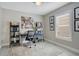 Inviting home office with a comfortable desk setup, bookshelves, and natural light at 9846 Palmetto Dunes Ct, Orlando, FL 32832