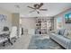 Bright office space featuring a large bookcase, comfortable seating, and a stylish blue rug at 9846 Palmetto Dunes Ct, Orlando, FL 32832