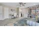 Bright office space featuring a large bookcase, comfortable seating, and a stylish blue rug at 9846 Palmetto Dunes Ct, Orlando, FL 32832