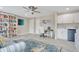 Bright office space featuring a large bookcase, comfortable seating, and a stylish blue rug at 9846 Palmetto Dunes Ct, Orlando, FL 32832
