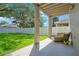 Covered patio with outdoor seating overlooking a well-maintained, fenced backyard at 9846 Palmetto Dunes Ct, Orlando, FL 32832