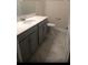 Bathroom featuring gray cabinets, a white countertop, a tiled floor, and a toilet at 12337 Turtle Grass Dr, Orlando, FL 32824