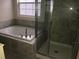 Bathroom featuring a tub, tiled shower, and a window for natural light at 12337 Turtle Grass Dr, Orlando, FL 32824