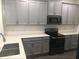 Well-lit kitchen with gray cabinets, modern appliances, white countertops, and a stainless steel sink at 12337 Turtle Grass Dr, Orlando, FL 32824