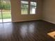 Spacious living room with hardwood floors, large sliding glass door, and windows at 12337 Turtle Grass Dr, Orlando, FL 32824