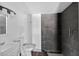 Bathroom featuring modern vanity and tiled shower with glass doors at 1257 N Pine Hills Rd, Orlando, FL 32808