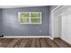Bedroom featuring a window, closet, wood laminate floors, and neutral gray paint at 1257 N Pine Hills Rd, Orlando, FL 32808