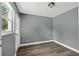 This bedroom features laminate flooring, neutral gray paint and a window for natural lighting at 1257 N Pine Hills Rd, Orlando, FL 32808