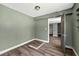 Bedroom featuring hardwood floors, green walls, and closet space at 1257 N Pine Hills Rd, Orlando, FL 32808