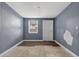 Bedroom featuring a window, vinyl floors, neutral paint and an exterior door at 1257 N Pine Hills Rd, Orlando, FL 32808