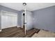 View of a bedroom with closet, laminate floors, and neutral gray paint at 1257 N Pine Hills Rd, Orlando, FL 32808