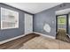 Bedroom featuring a window, vinyl floors, neutral paint and an exterior door at 1257 N Pine Hills Rd, Orlando, FL 32808
