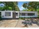 Charming single-story home with a well-maintained yard and distinctive architectural details at 1257 N Pine Hills Rd, Orlando, FL 32808