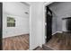 Hallway featuring gray walls and wood-look vinyl floors, leading to bedrooms at 1257 N Pine Hills Rd, Orlando, FL 32808
