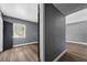 Hallway featuring gray walls and wood-look vinyl floors, leading to bedrooms at 1257 N Pine Hills Rd, Orlando, FL 32808