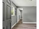 Hallway with hardwood floors, light gray paint, and views to other rooms at 1257 N Pine Hills Rd, Orlando, FL 32808