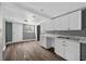 Functional kitchen area with white cabinets, hardwood floors, and a view to the outside at 1257 N Pine Hills Rd, Orlando, FL 32808