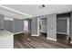 Open floor plan living room with hardwood floors, light gray paint, and views to other rooms at 1257 N Pine Hills Rd, Orlando, FL 32808