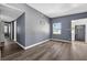 Open-concept living room with hardwood floors, light gray walls, and a bright, airy feel at 1257 N Pine Hills Rd, Orlando, FL 32808