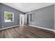 Bright living room featuring hardwood flooring, light gray paint, and exterior views at 1257 N Pine Hills Rd, Orlando, FL 32808