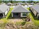 Aerial view of the home showing the backyard, screened-in patio, and lawn at 1388 Lombardi Ct, Kissimmee, FL 34759