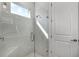Modern glass enclosed shower with tile surround and a built-in seat at 1388 Lombardi Ct, Kissimmee, FL 34759