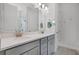 Bright bathroom featuring double sinks with gray cabinetry and white countertops at 1388 Lombardi Ct, Kissimmee, FL 34759