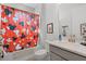 Well-lit bathroom with a shower/tub combo and gray vanity at 1388 Lombardi Ct, Kissimmee, FL 34759