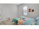Bright bedroom with a large window and vibrant themed bedspread at 1388 Lombardi Ct, Kissimmee, FL 34759