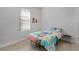 Cozy bedroom featuring a whimsical-themed bedspread and natural light at 1388 Lombardi Ct, Kissimmee, FL 34759