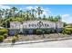 Stone community sign, SOLIVITA, with palm trees against a blue sky, creating a welcoming entrance at 1388 Lombardi Ct, Kissimmee, FL 34759