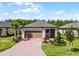 Charming single-story home with a paver driveway and two-car garage at 1388 Lombardi Ct, Kissimmee, FL 34759