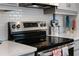 Close-up of a stainless steel stove with white subway tile backsplash at 1388 Lombardi Ct, Kissimmee, FL 34759