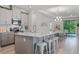 Open-concept kitchen featuring gray cabinets, an island, and stainless steel appliances at 1388 Lombardi Ct, Kissimmee, FL 34759