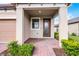 Inviting front porch with brick pavers and a decorative glass front door at 1388 Lombardi Ct, Kissimmee, FL 34759