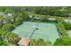 Aerial view showcasing well-maintained tennis courts, surrounded by lush greenery and palm trees at 1388 Lombardi Ct, Kissimmee, FL 34759