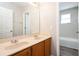 Bathroom featuring double sinks, granite counters and a tub/shower combo at 148 Conch Dr, Kissimmee, FL 34759