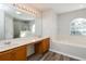 Bright bathroom featuring a double sink vanity with a large tub and shower at 148 Conch Dr, Kissimmee, FL 34759