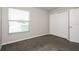 Bedroom with a window, plush carpet, base trim, and a closet at 148 Conch Dr, Kissimmee, FL 34759